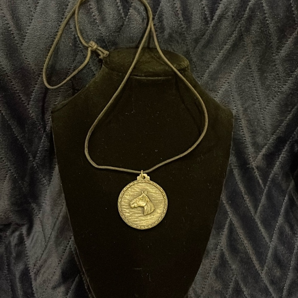 Vintage. Possible pewter horse  on a cord neckace